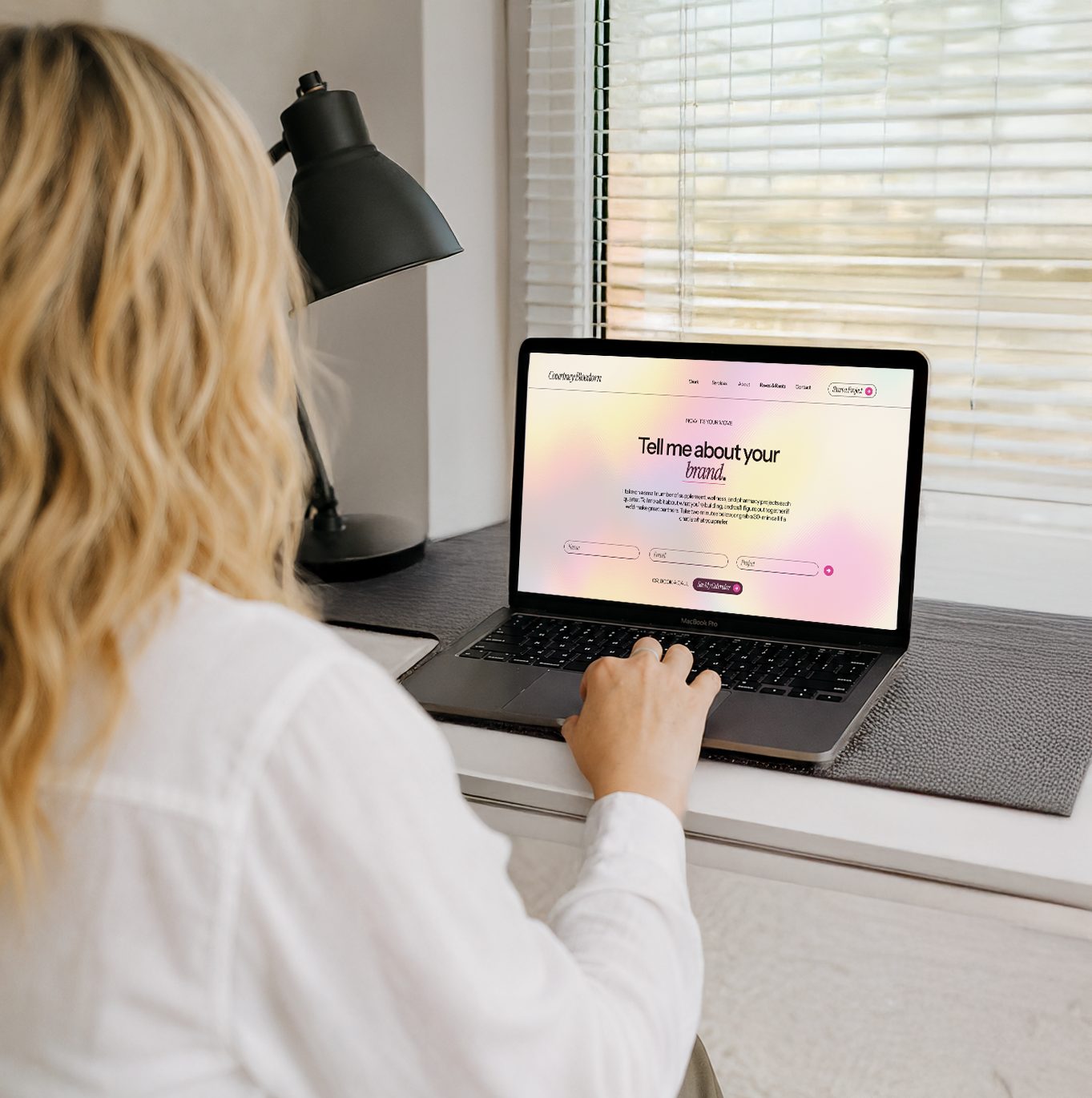 Courtney working at her desk during a vision call